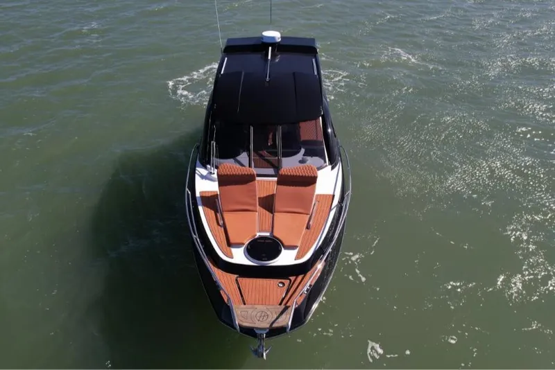 Slide: The Image of 2025 Hanover 355 Outboard boat on water, aerial view, sleek design. - 3