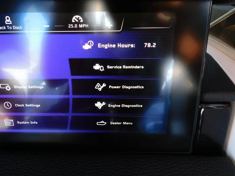 Slide: The Image of Dashboard display of 2023 Nautique Super Air Nautique G23 Paragon showing engine hours and settings. - 13