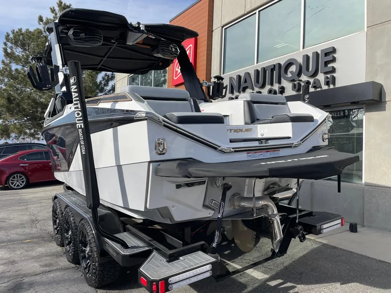 Slide: The Image of 2023 Nautique Super Air Nautique G23 Paragon boat on trailer outside dealership. - 3
