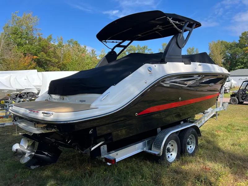 Slide: The Image of 2022 Sea Ray SLX 250 boat on trailer, black and white design, outdoor setting. - 16