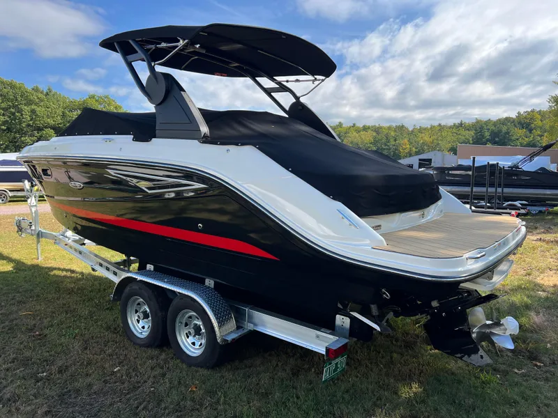 Slide: The Image of 2022 Sea Ray SLX 250 boat on trailer, black with red accents, outdoor setting. - 17