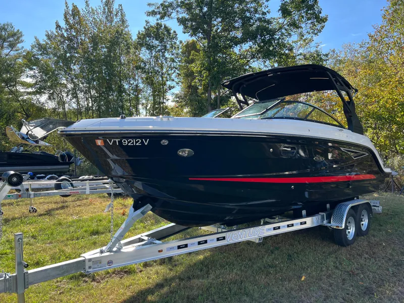 Slide: The Image of 2022 Sea Ray SLX 250 boat on trailer, parked outdoors. - 21