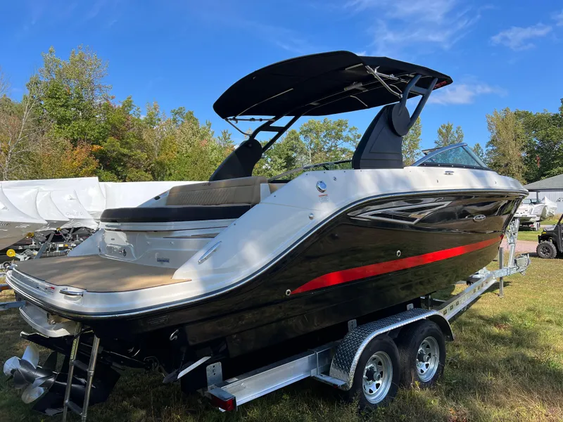 Slide: The Image of 2022 Sea Ray SLX 250 boat on trailer, black and white design, outdoor setting. - 23