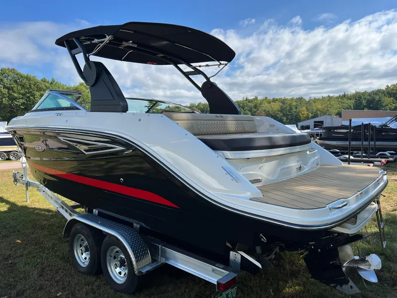 Slide: The Image of 2022 Sea Ray SLX 250 boat on trailer, sleek design, black and white exterior. - 24