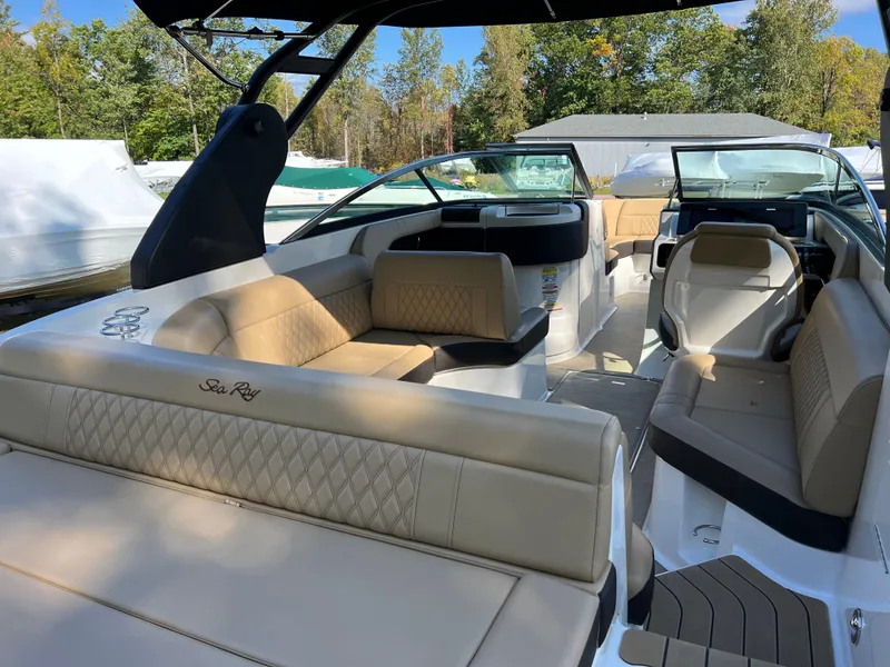 Slide: The Image of 2022 Sea Ray SLX 250 boat interior with luxurious beige seating and modern design. - 26