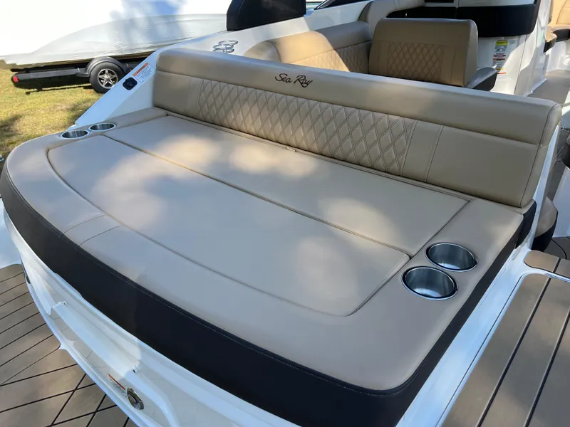 Slide: The Image of 2022 Sea Ray SLX 250 boat with beige seating and cup holders. - 27