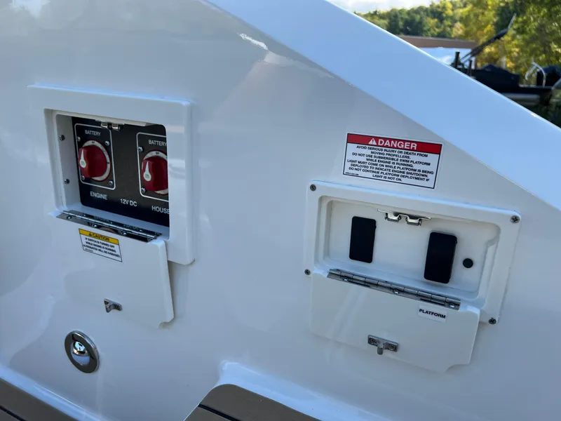 Slide: The Image of Close-up of 2022 Sea Ray SLX 250 boat control panels and safety warnings. - 30