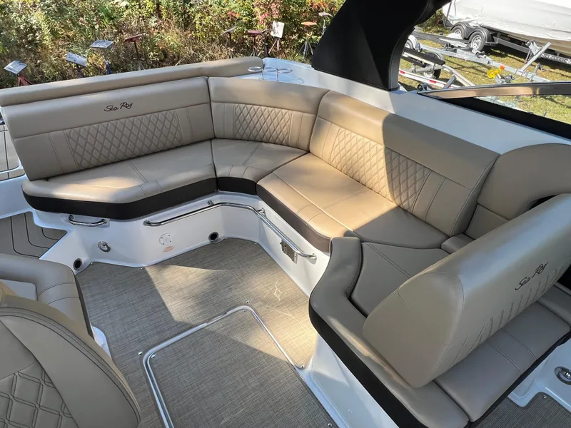 Slide: The Image of 2022 Sea Ray SLX 250 boat interior with beige leather seating and elegant design. - 32