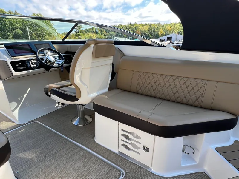 Slide: The Image of Luxurious interior of 2022 Sea Ray SLX 250 boat with plush seating and modern dashboard. - 33