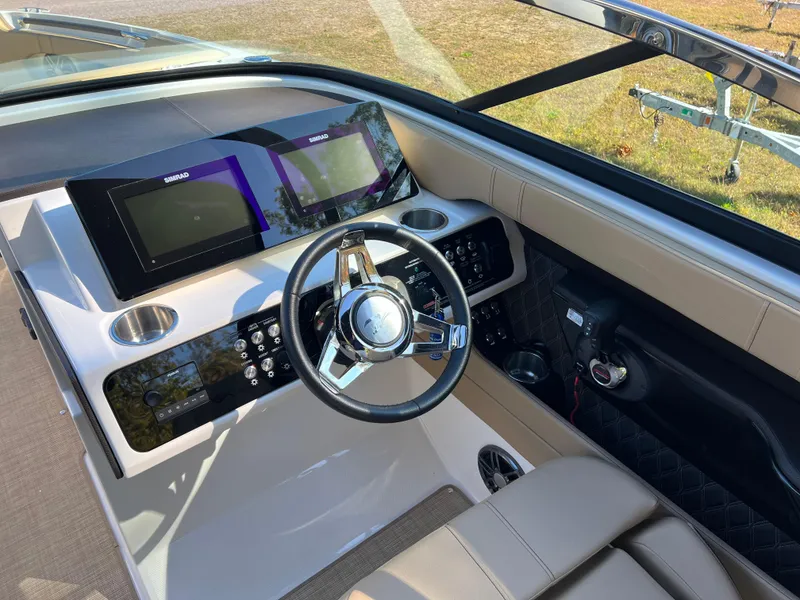 Slide: The Image of 2022 Sea Ray SLX 250 helm with modern controls and dual displays. - 35