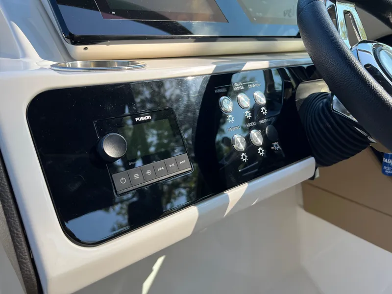 Slide: The Image of 2022 Sea Ray SLX 250 dashboard with control panel and steering wheel. - 38