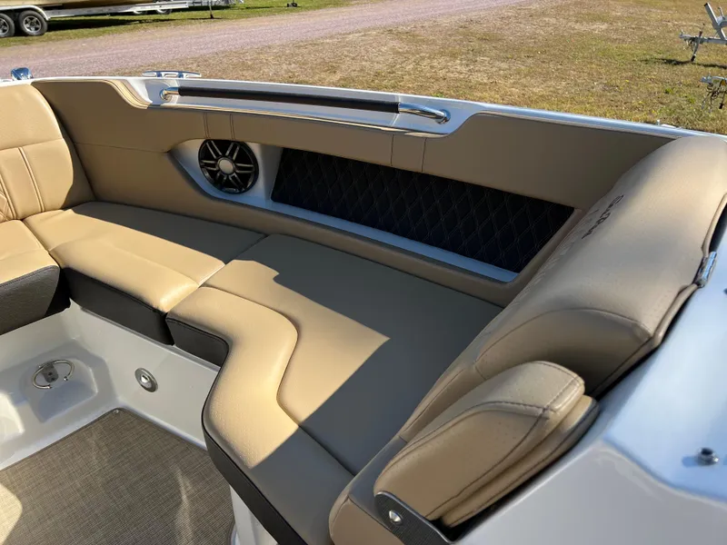 Slide: The Image of 2022 Sea Ray SLX 250 boat interior with tan leather seating and speaker. - 42