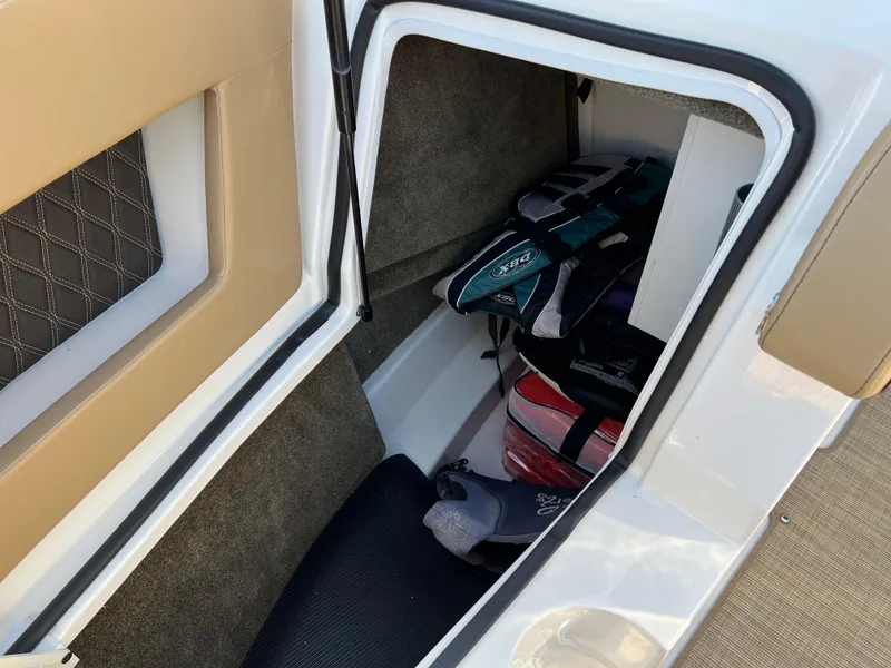 Slide: The Image of Storage compartment in 2022 Sea Ray SLX 250 boat with life jackets. - 44