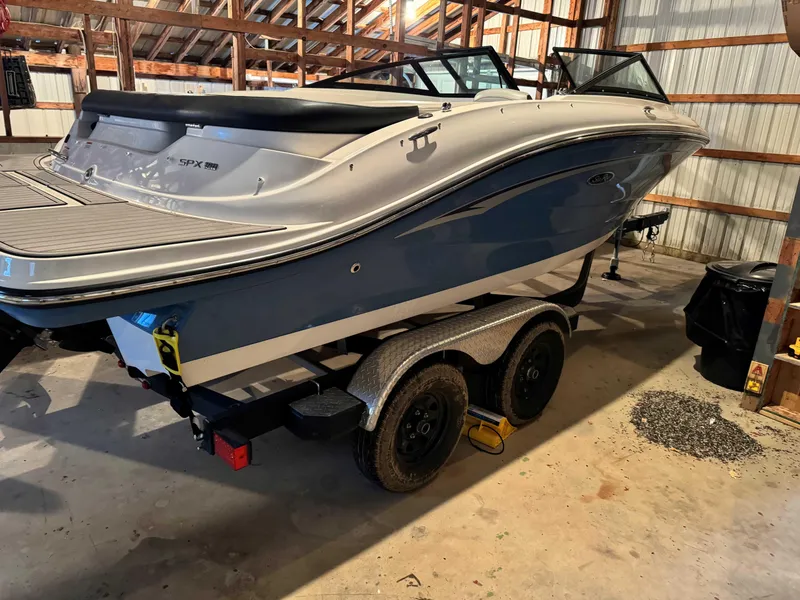 The Image of 2022 Sea Ray SPX 190 boat on trailer in a garage. - 0