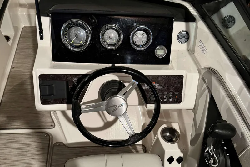 Slide: The Image of 2022 Sea Ray SPX 190 boat dashboard with steering wheel and gauges. - 10