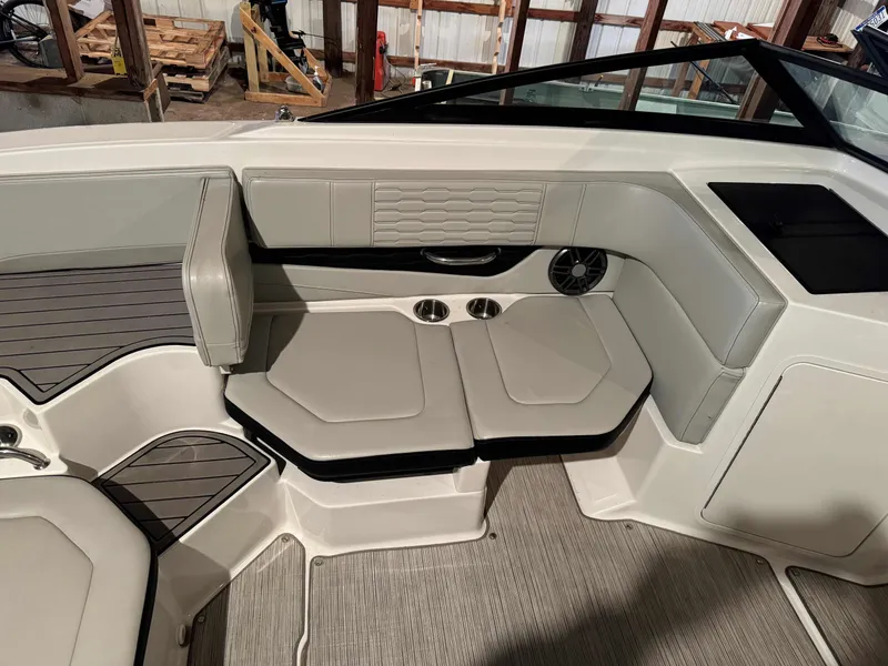 Slide: The Image of 2022 Sea Ray SPX 190 boat interior with cushioned seating and modern design. - 11