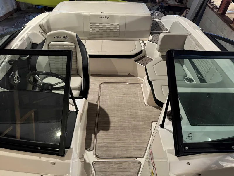 Slide: The Image of 2022 Sea Ray SPX 190 boat interior with seating and steering wheel. - 12