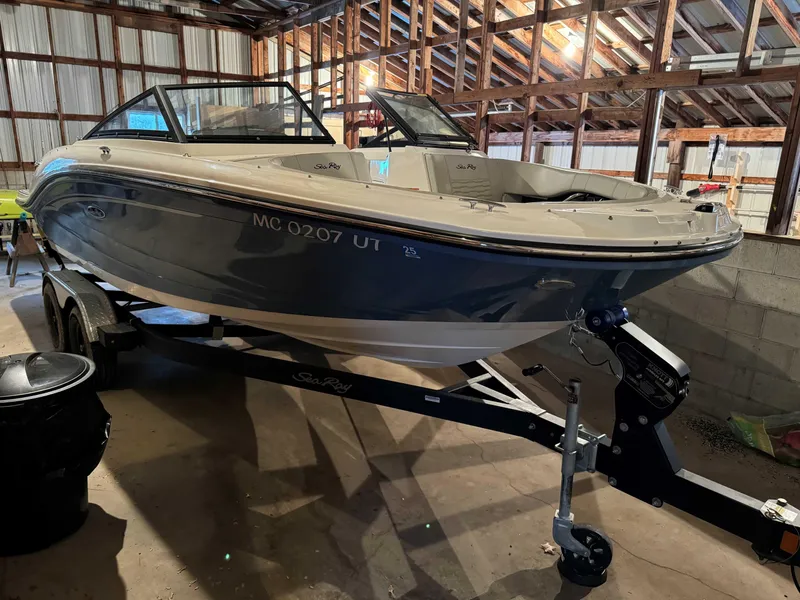 Slide: The Image of 2022 Sea Ray SPX 190 boat on trailer in a wooden garage. - 2