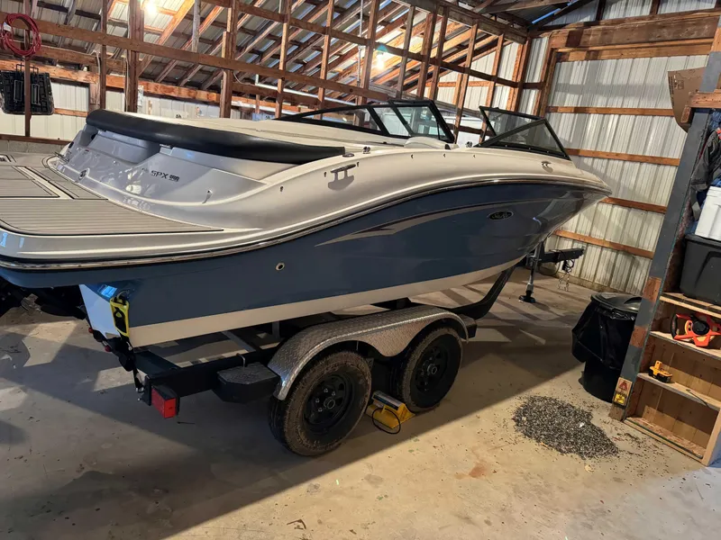 Slide: The Image of 2022 Sea Ray SPX 190 boat in storage, blue and white, on a trailer. - 4
