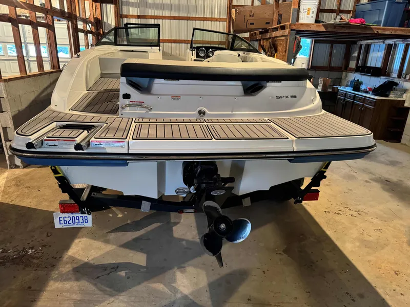 Slide: The Image of 2022 Sea Ray SPX 190 boat in a garage, rear view showing swim platform and propeller. - 5