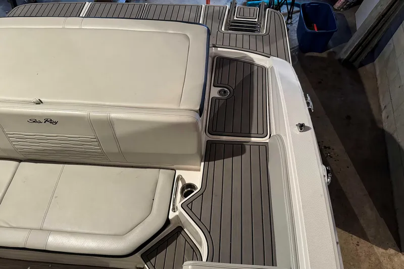 Slide: The Image of 2022 Sea Ray SPX 190 boat interior with cushioned seating and sleek design. - 8