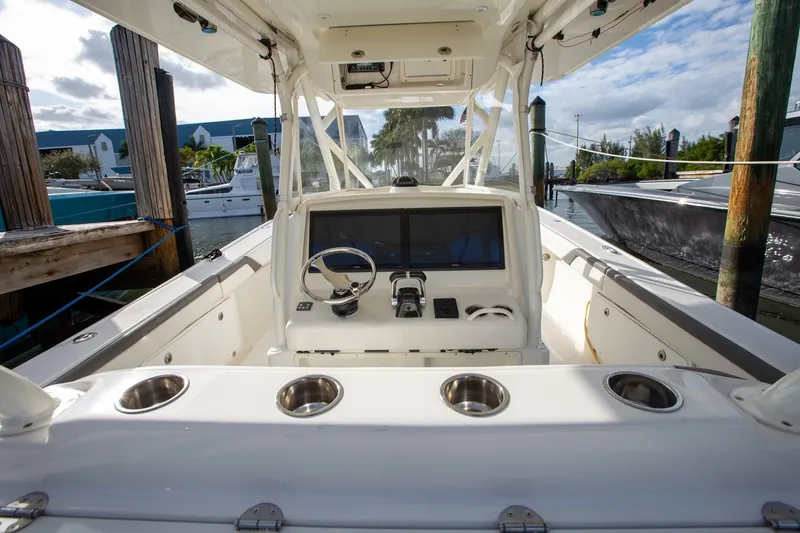 Slide: The Image of 2015 Yellowfin 39 Offshore boat cockpit with steering wheel and controls. - 10