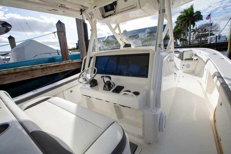Slide: The Image of 2015 Yellowfin 39 Offshore boat interior with helm and seating area. - 11