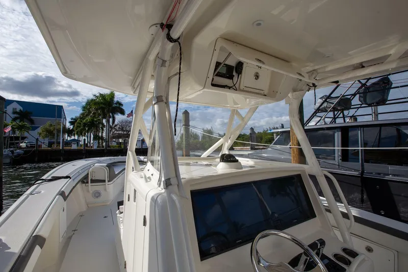 Slide: The Image of 2015 Yellowfin 39 Offshore boat interior with steering console and navigation equipment. - 14