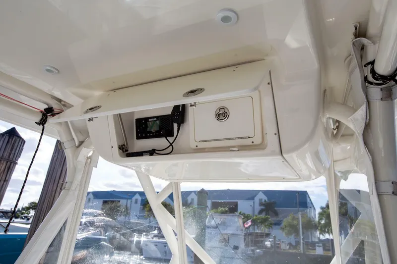 Slide: The Image of 2015 Yellowfin 39 Offshore boat interior with storage compartment and electronic equipment. - 16