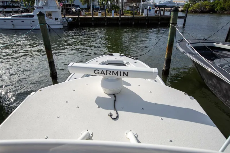 Slide: The Image of 2015 Yellowfin 39 Offshore boat with Garmin radar, docked in a marina. - 17