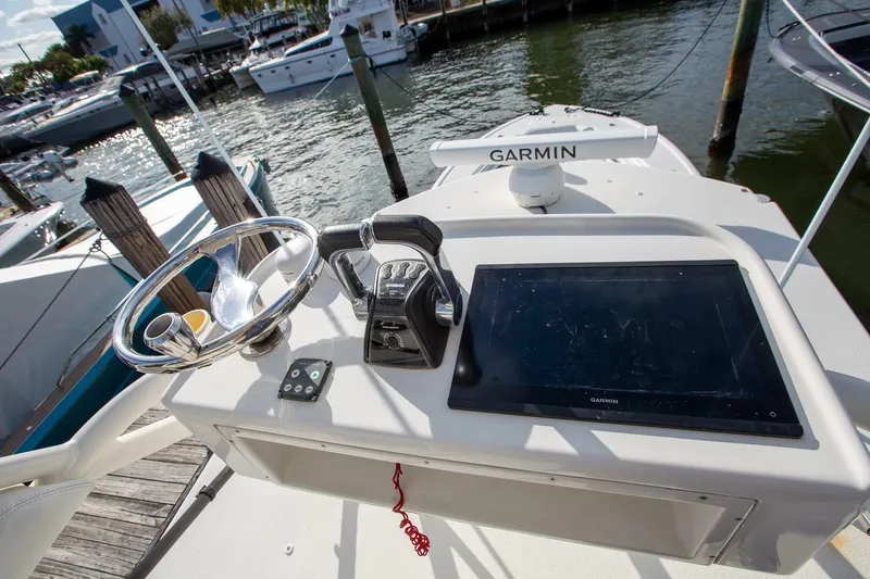 Slide: The Image of 2015 Yellowfin 39 Offshore boat helm with Garmin navigation system at dock. - 18