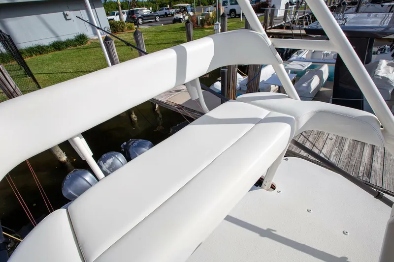 Slide: The Image of 2015 Yellowfin 39 Offshore boat with white seating and dock view. - 19