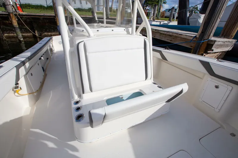 Slide: The Image of 2015 Yellowfin 39 Offshore boat interior with white seating and console. - 20