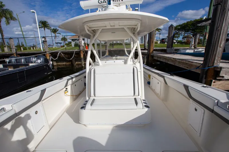 Slide: The Image of 2015 Yellowfin 39 Offshore boat with spacious deck and seating, docked under clear skies. - 21