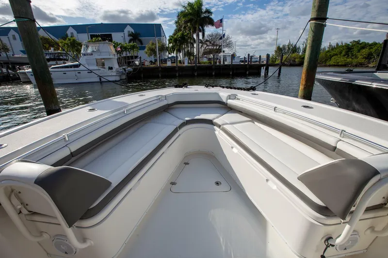 Slide: The Image of 2015 Yellowfin 39 Offshore boat with spacious seating, docked at a marina. - 22