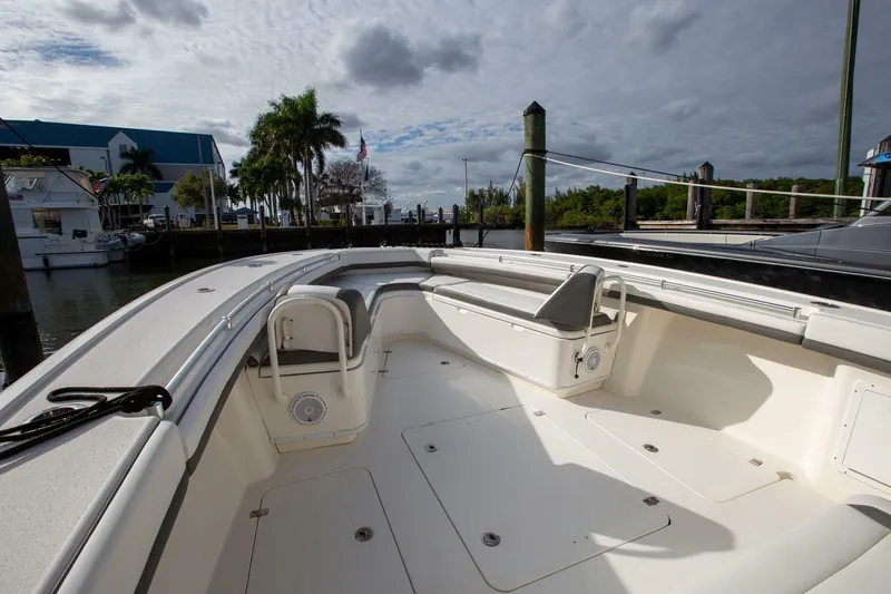Slide: The Image of 2015 Yellowfin 39 Offshore boat interior at dock, featuring spacious seating and storage. - 23