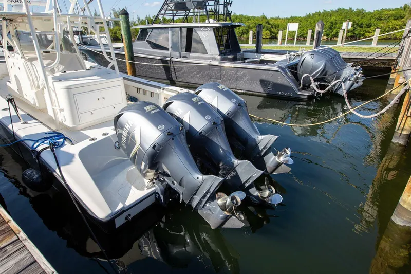 Slide: The Image of 2015 Yellowfin 39 Offshore boat with triple outboard engines docked at marina. - 24