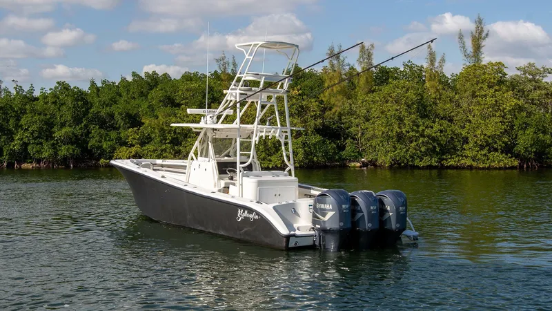 Slide: The Image of 2015 Yellowfin 39 Offshore boat with triple Yamaha engines on calm water. - 3