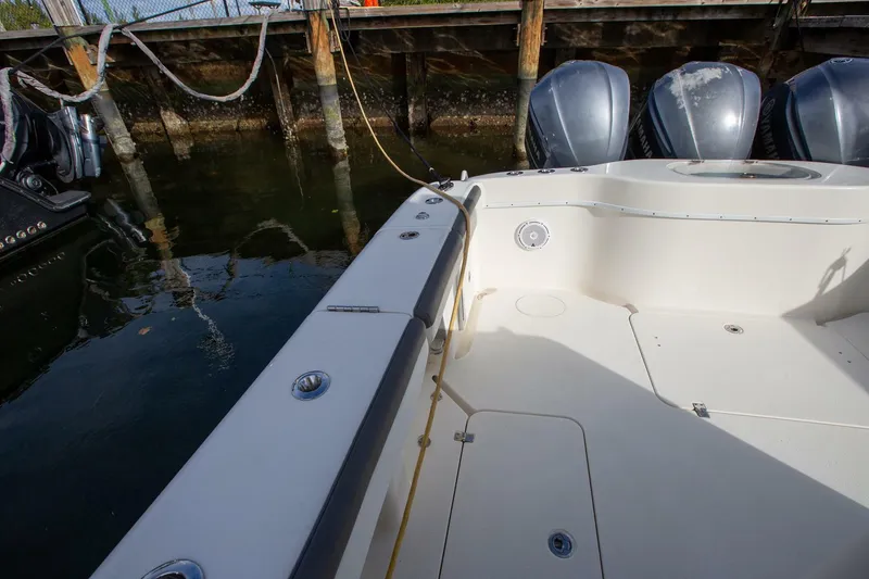 Slide: The Image of 2015 Yellowfin 39 Offshore boat docked, featuring spacious deck and powerful engines. - 8
