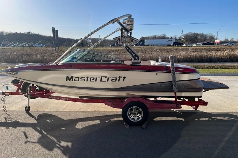 Slide: The Image of 2007 MasterCraft X2 boat on trailer, parked outdoors on a sunny day. - 5