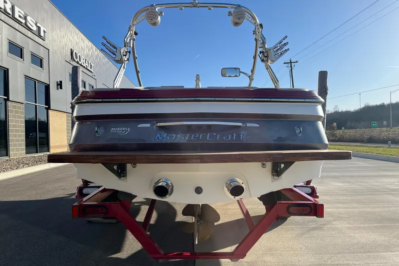 Slide: The Image of 2007 MasterCraft X2 boat rear view in a sunny outdoor setting. - 7