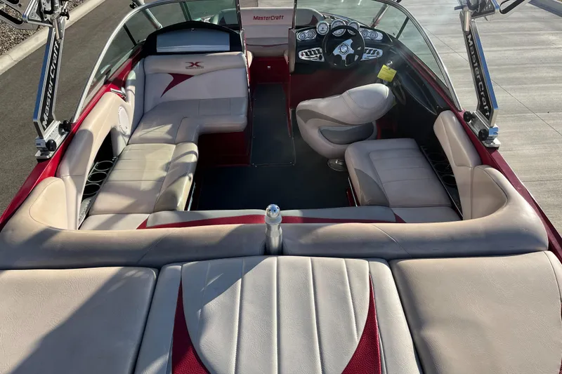 Slide: The Image of 2007 MasterCraft X2 boat interior with beige seating and red accents. - 9