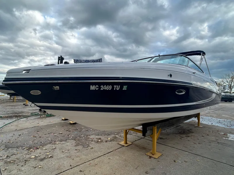 Slide: The Image of 2015 Rinker Captiva 276 BR boat on stands under cloudy sky. - 0