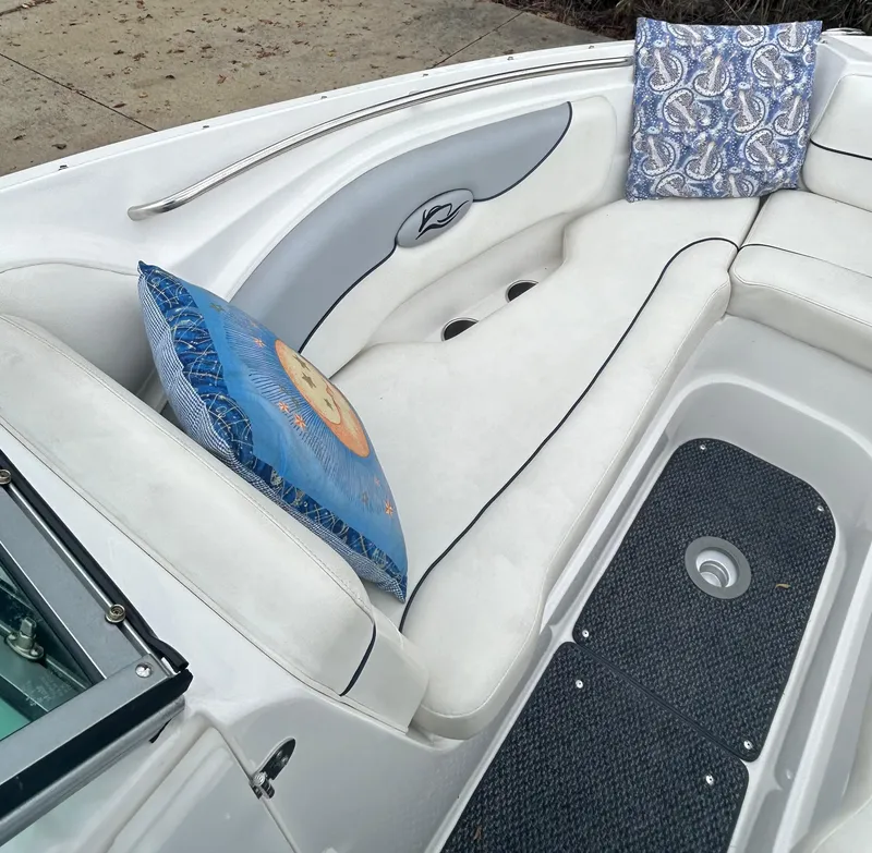 Slide: The Image of 2015 Rinker Captiva 276 BR boat interior with decorative cushions. - 12