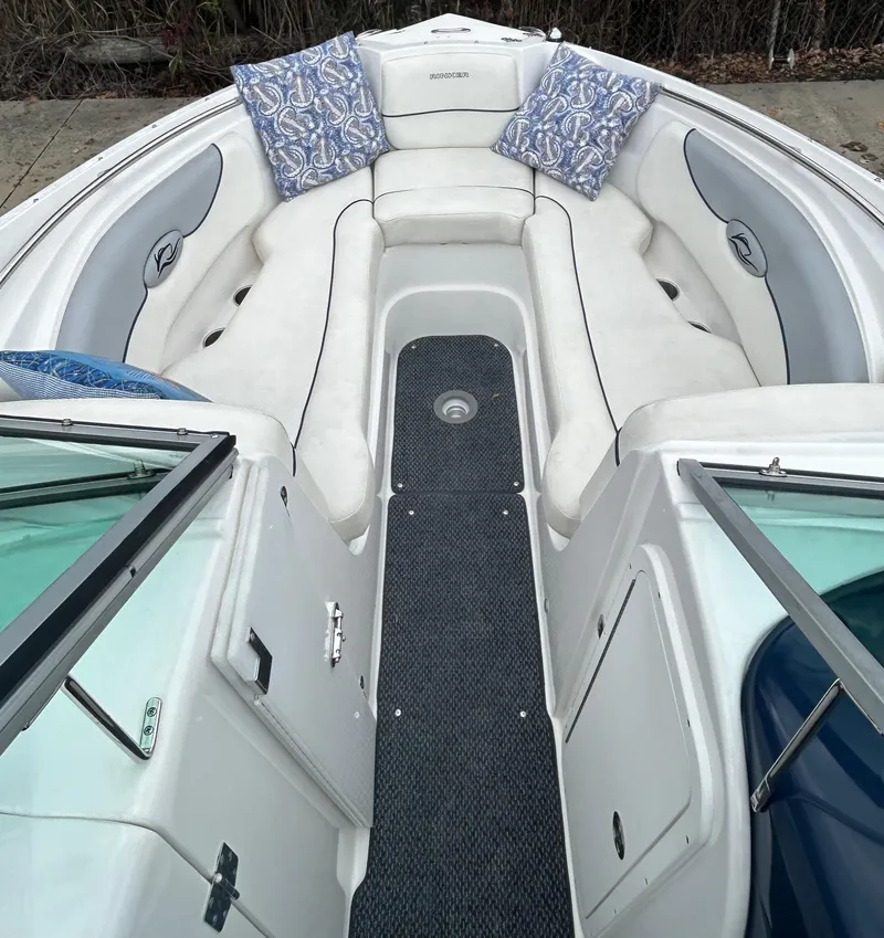 Slide: The Image of 2015 Rinker Captiva 276 BR boat interior with white seating and blue patterned cushions. - 14