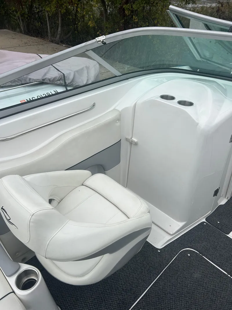 Slide: The Image of 2015 Rinker Captiva 276 BR boat interior with white seating and sleek design. - 20