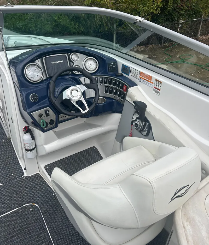 Slide: The Image of 2015 Rinker Captiva 276 BR boat cockpit with steering wheel and control panel. - 21
