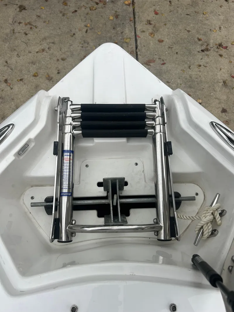 Slide: The Image of 2015 Rinker Captiva 276 BR boat ladder on deck, stainless steel construction. - 23