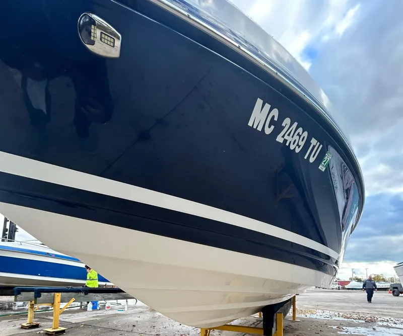 Slide: The Image of 2015 Rinker Captiva 276 BR boat on display, showcasing sleek blue and white hull design. - 3