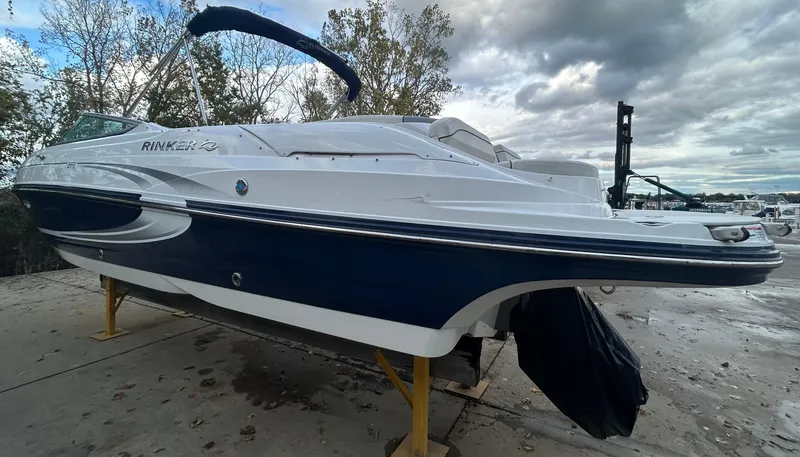Slide: The Image of 2015 Rinker Captiva 276 BR boat on a stand, cloudy sky background. - 4